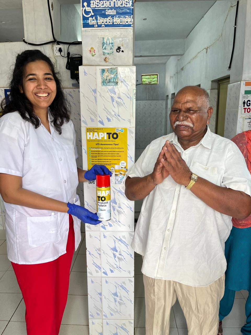 Photo of Dr.Divya Rathod holding a canister of Hapito in a bathroom